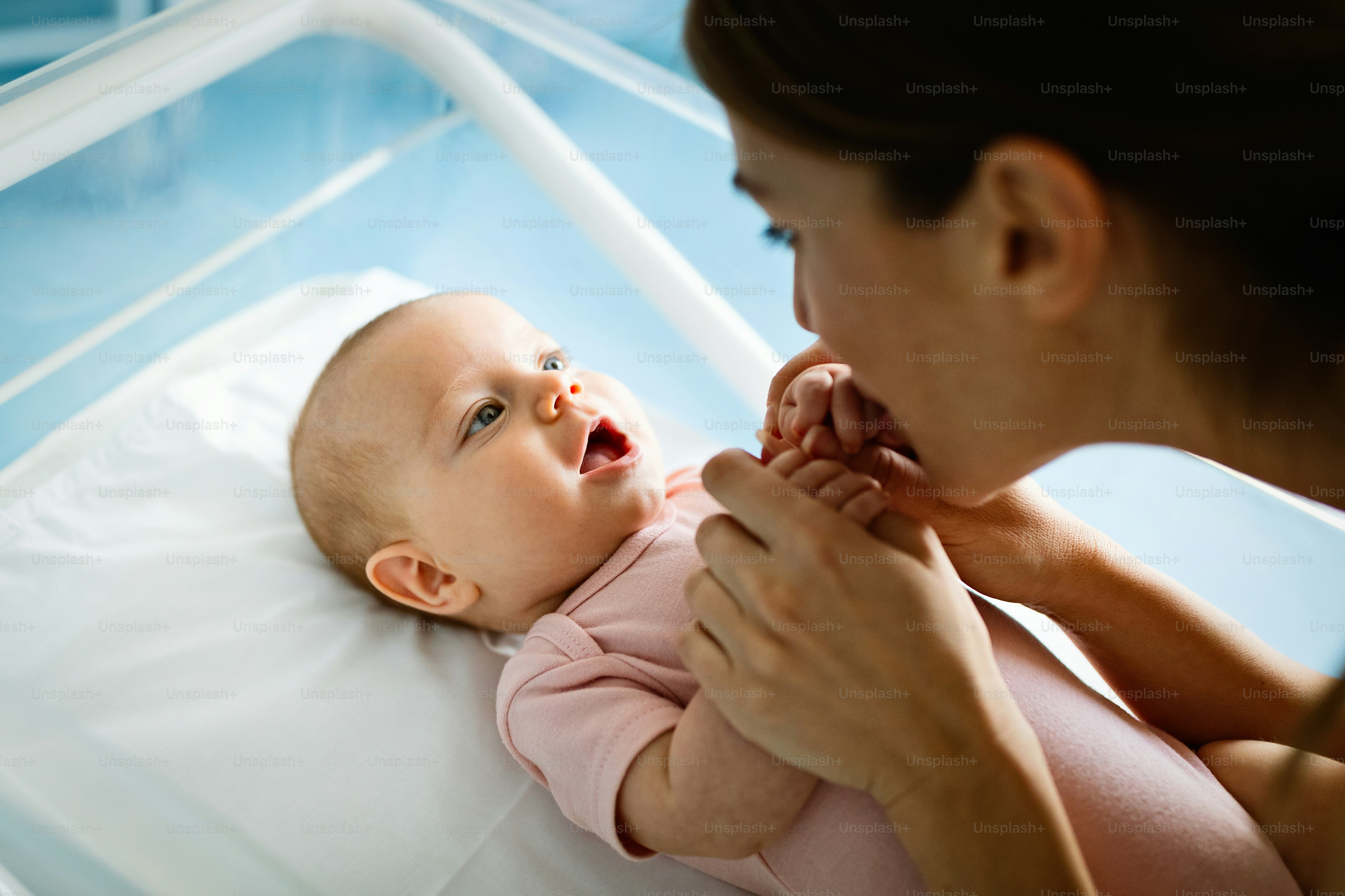 Beautiful young mother and her newborn baby together. Love, happiness, family concept.