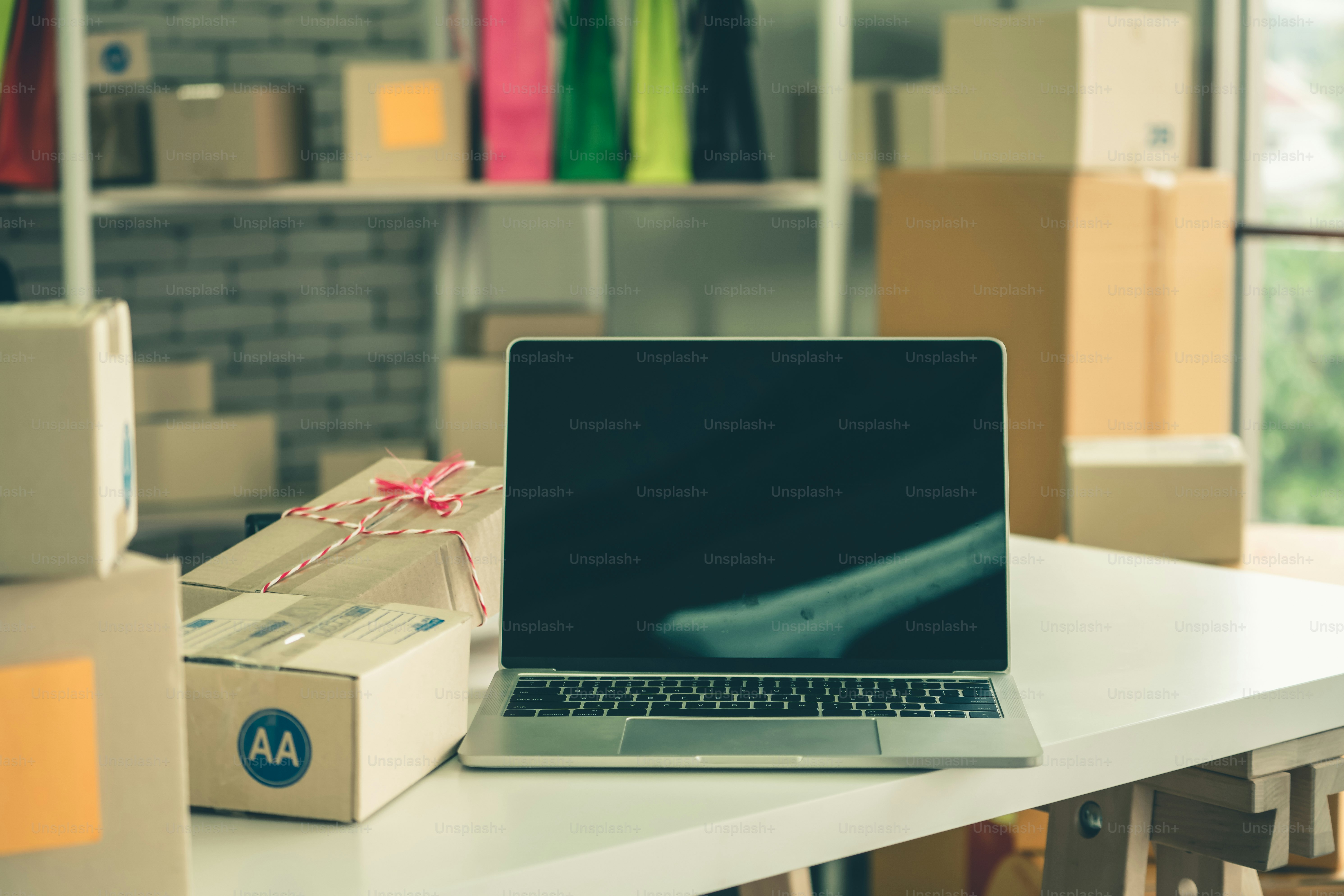 Laptop computer with empty screen on shipping box background. Concept ...