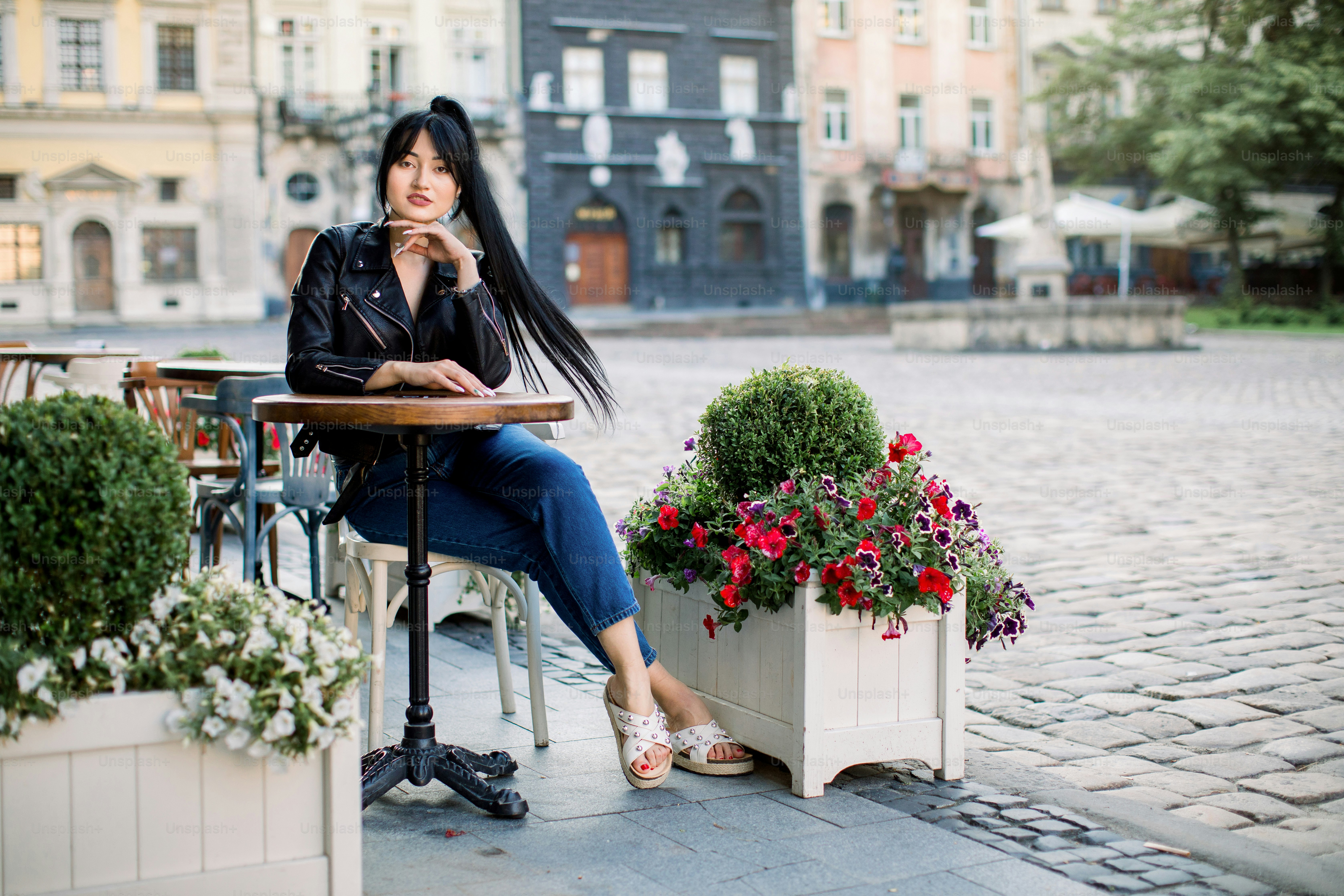 Happy Asian brunette woman at outdoors cafe, sitting at the table ...