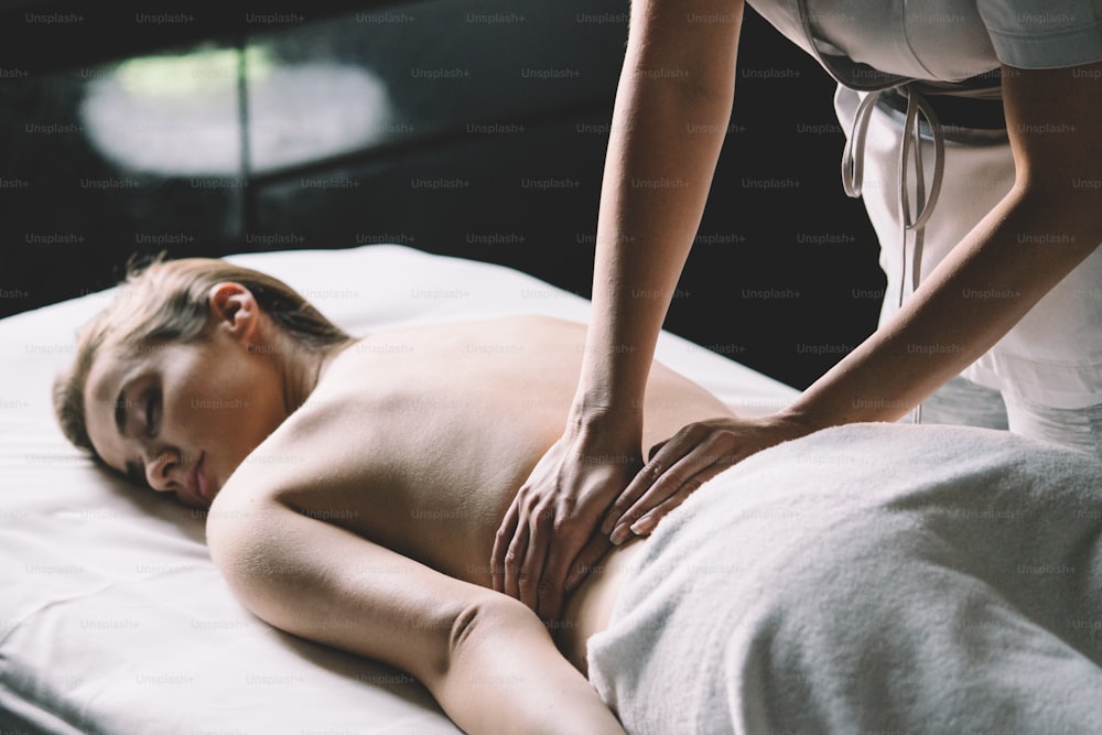 Young and healthy woman in spa salon. Massage therapy and beauty treatments.