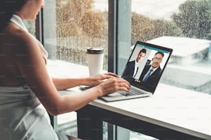 Video call business people meeting on virtual workplace or remote office. Telework conference call using smart video technology to communicate colleague in professional corporate business.