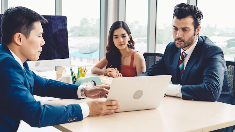 Financial advisor meeting with clients at a modern office table