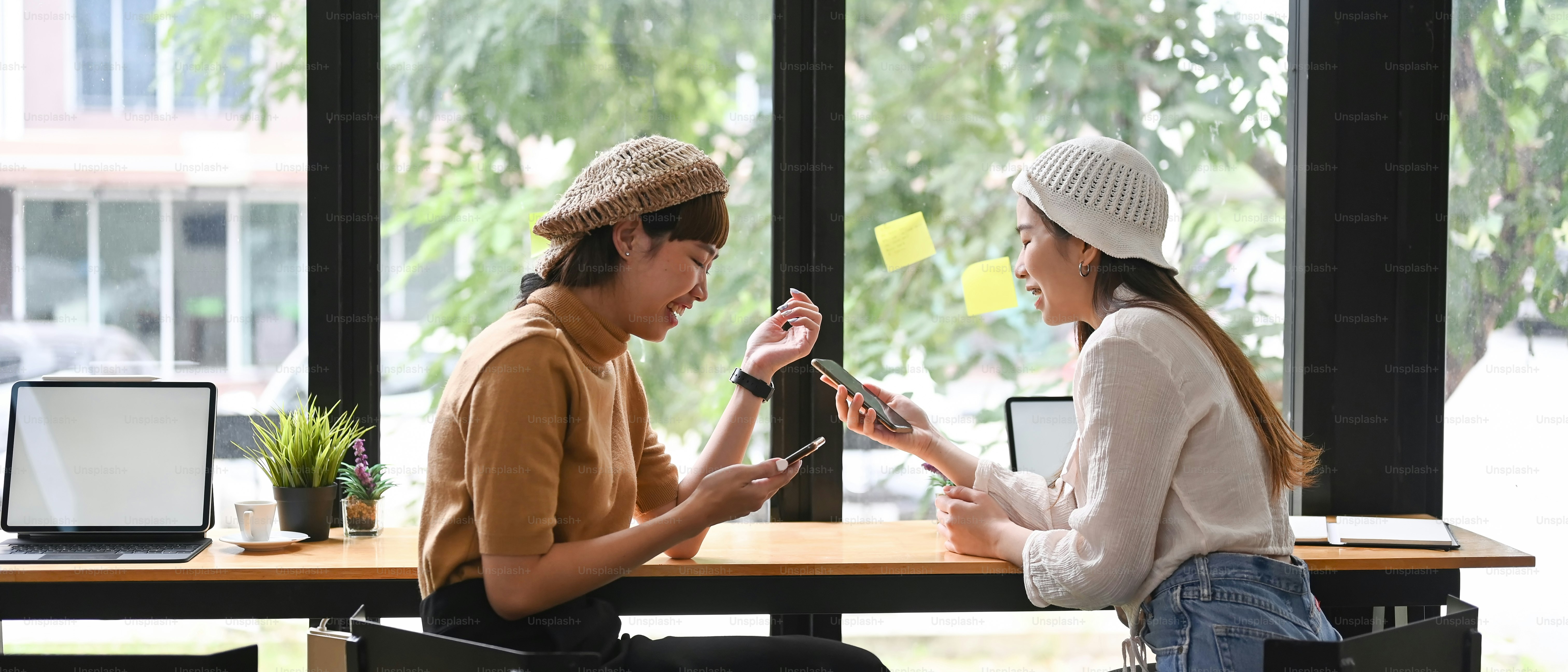 Young female freelancer talking about new startup project with colleague in office.