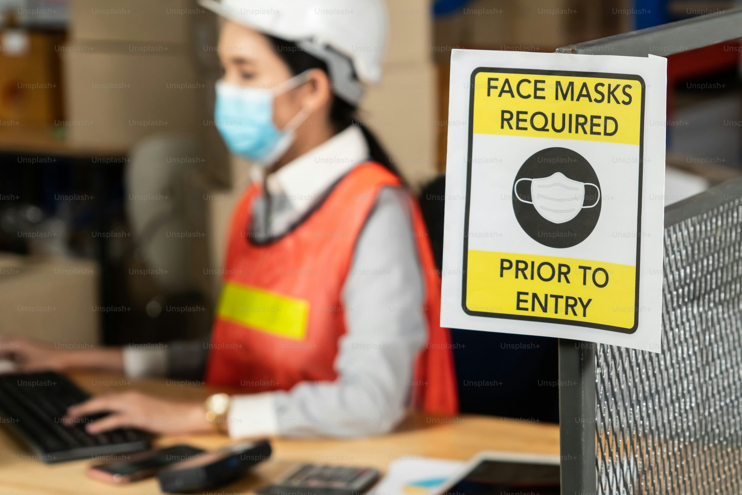 Vorsichtsschild in der Fabrik, das die Arbeiter der Industrie warnt, um die Ausbreitung des Covid-19-Coronavirus während der Wiedereröffnung des Arbeitsbetriebs nach der Epidemiekrise zu verhindern. Konzept für sicheres Arbeiten .
