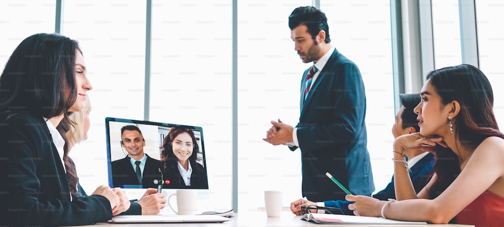 Video call group business people meeting on virtual workplace or remote office. Telework conference call using smart video technology to communicate colleague in professional corporate business.