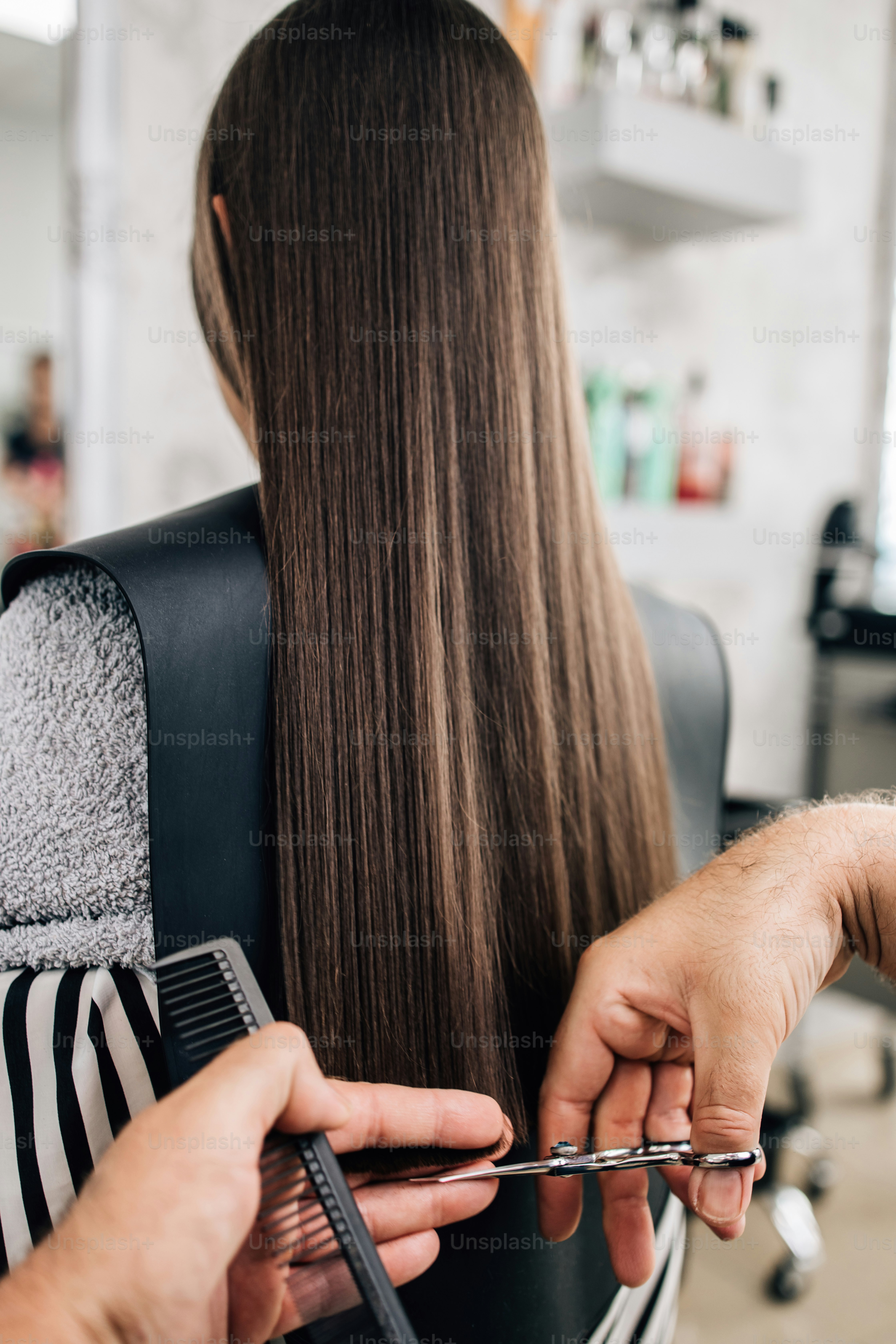 Young girl at hairstyle treatment while professional hairdresser gently washing her hair.