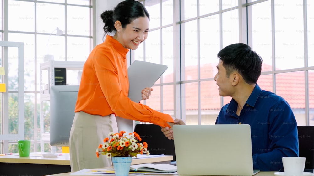 Business people handshake with friend at office showing trust , friendship and success celebration .