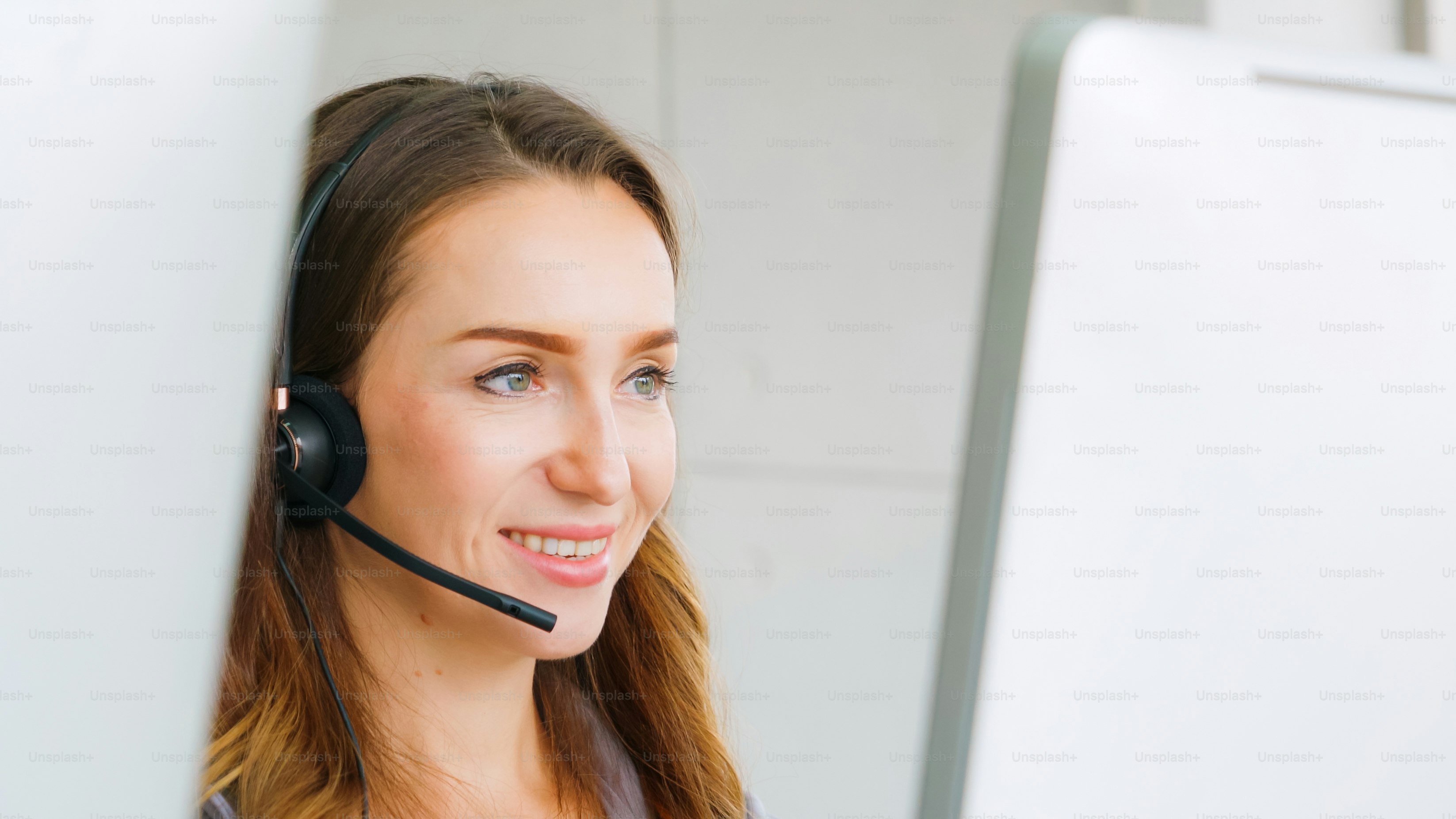 Business people wearing headset working in office to support remote customer or colleague. Call center, telemarketing, customer support agent provide service on telephone video conference call.