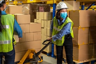 Factory industry worker working with face mask to prevent Covid-19 Coronavirus spreading during job reopening period .