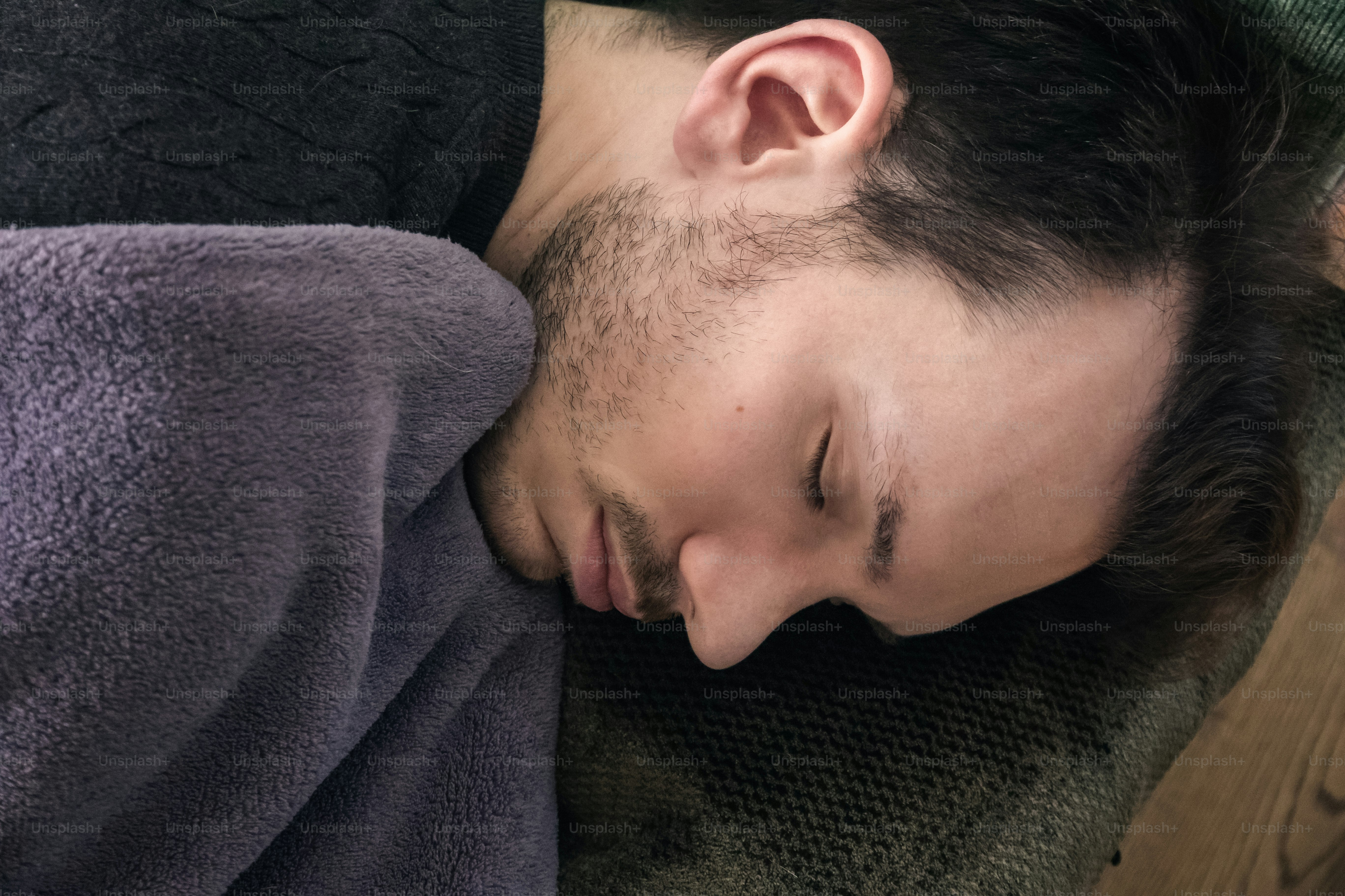A caucasian man taking an afternoon nap on couch at home, sleeping concept
