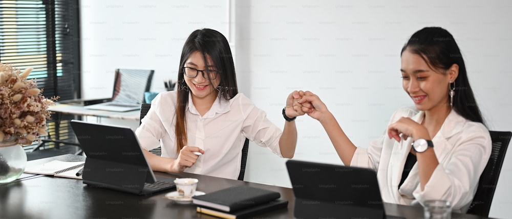 Young businesswoman doing fist bump celebrate after work done complete.