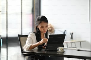 A businesswoman using tablet via wireless internet technology working online at office.