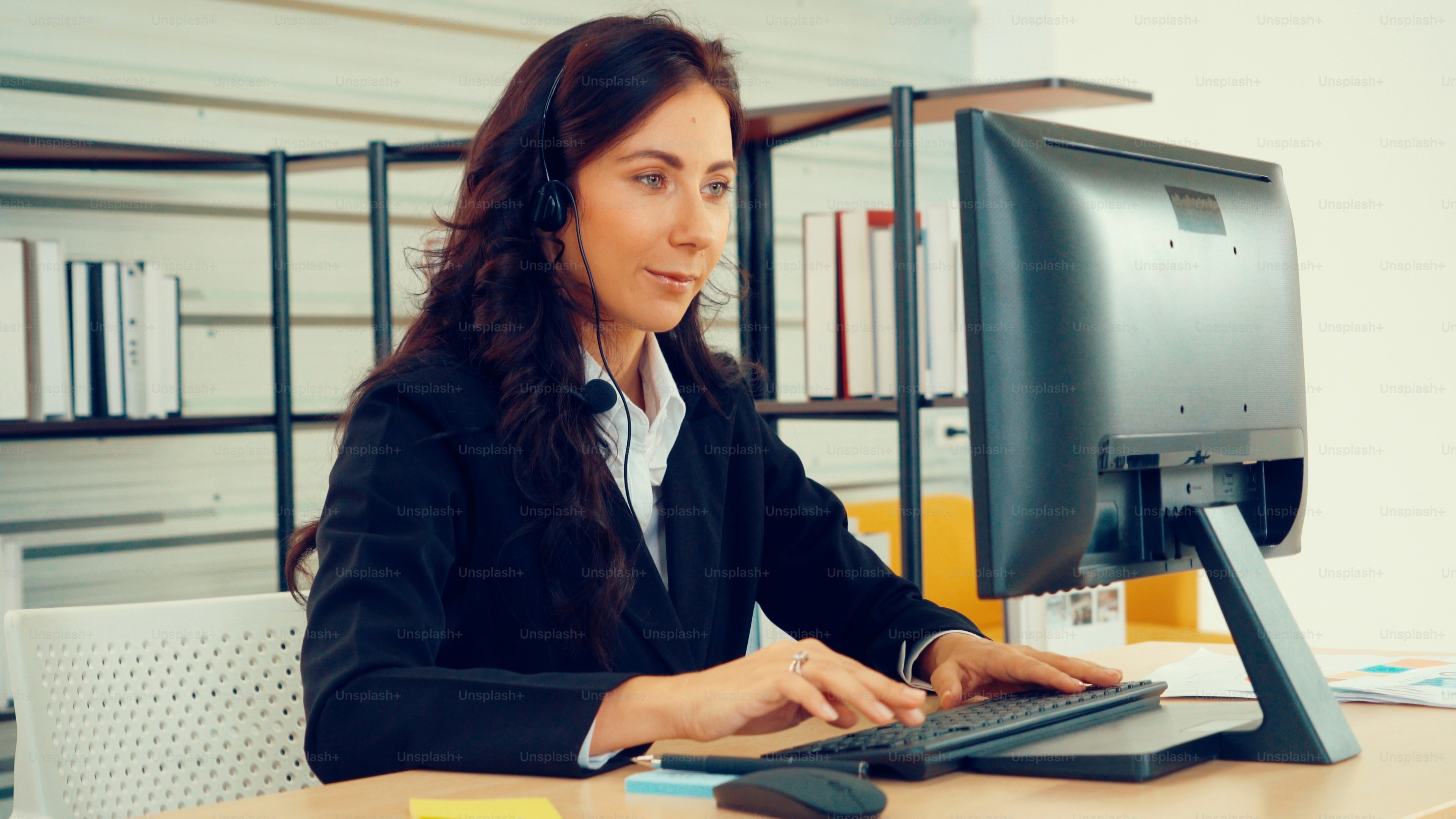 Geschäftsleute, die ein Headset tragen, arbeiten im Büro, um entfernte Kunden oder Kollegen zu unterstützen. Call-Center, Telemarketing, Kundendienstmitarbeiter bieten Service auf Telefon-Videokonferenz-Anruf.