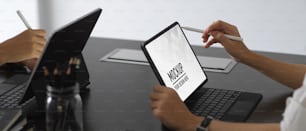Side view of two workers working together with digital tablet include clipping path