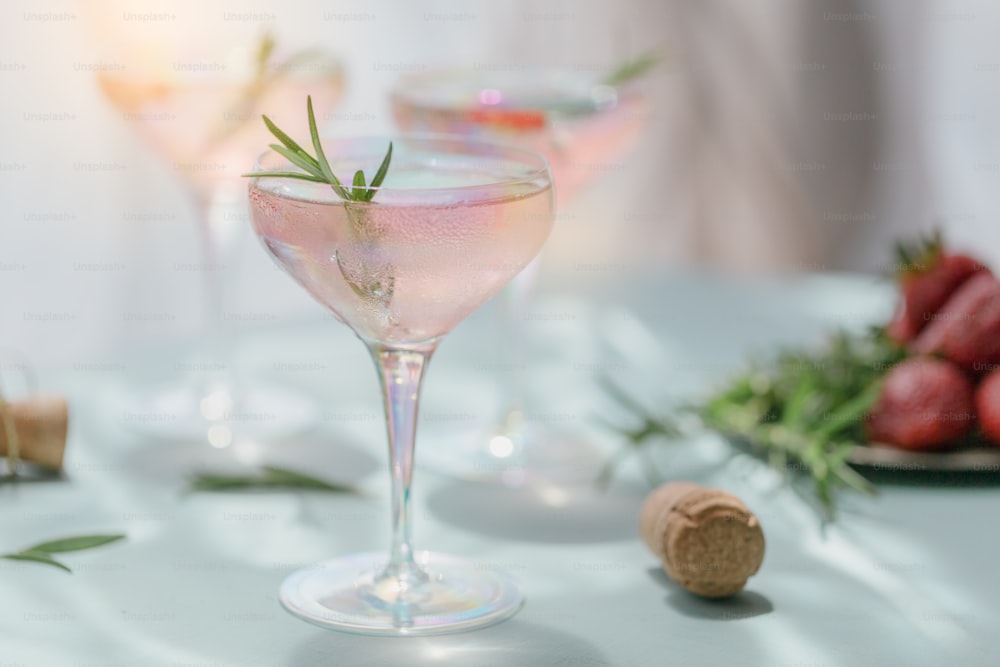 Glass of strawberry cocktail or mocktail, refreshing summer drink with crushed ice and sparkling water on light blue background. Beverage photography.