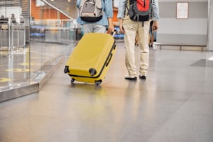 Cropped photo of a senior female passenger and her husband standing at the airport terminal