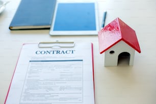 House and land purchase contract form on the brokerage desk of a real estate company.
