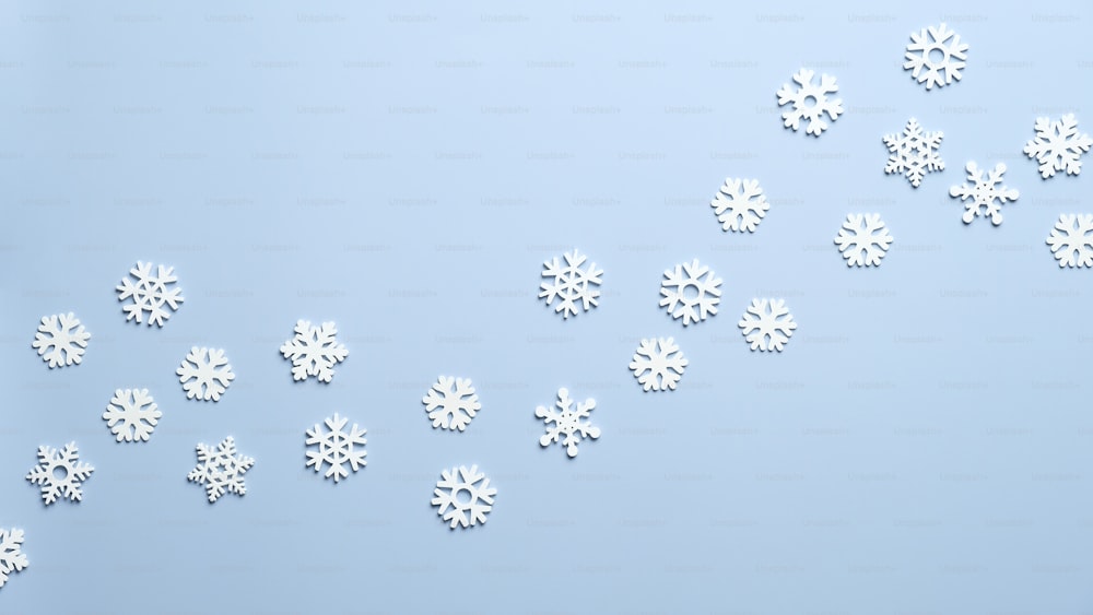 White wooden snowflakes on blue background. Christmas, New Year, winter holidays pattern.