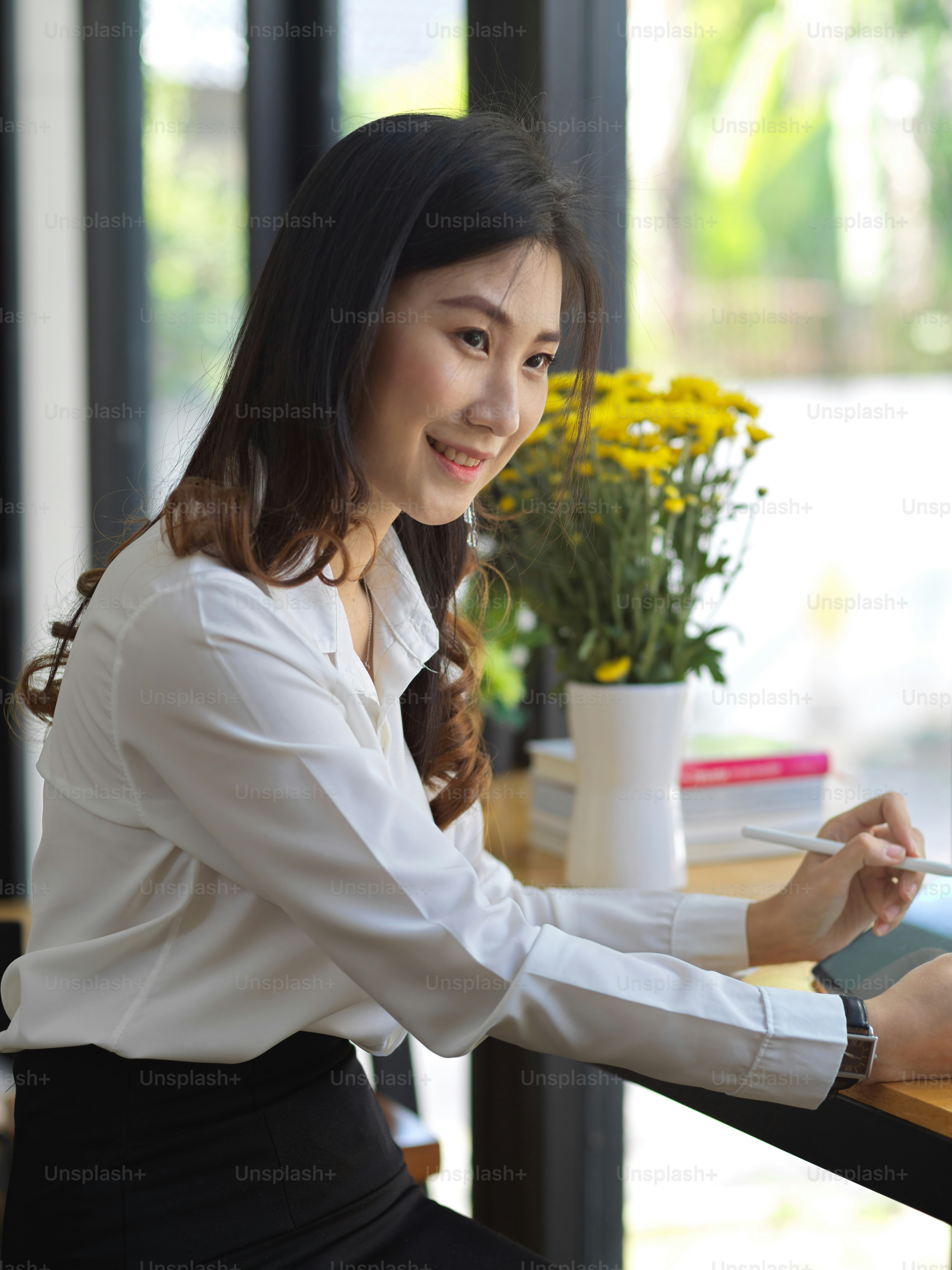 Portrait of cheerful female student doing assignment with digital ...