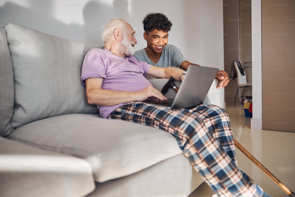 African American male volunteer spending his spare time with a resident of a retirement home