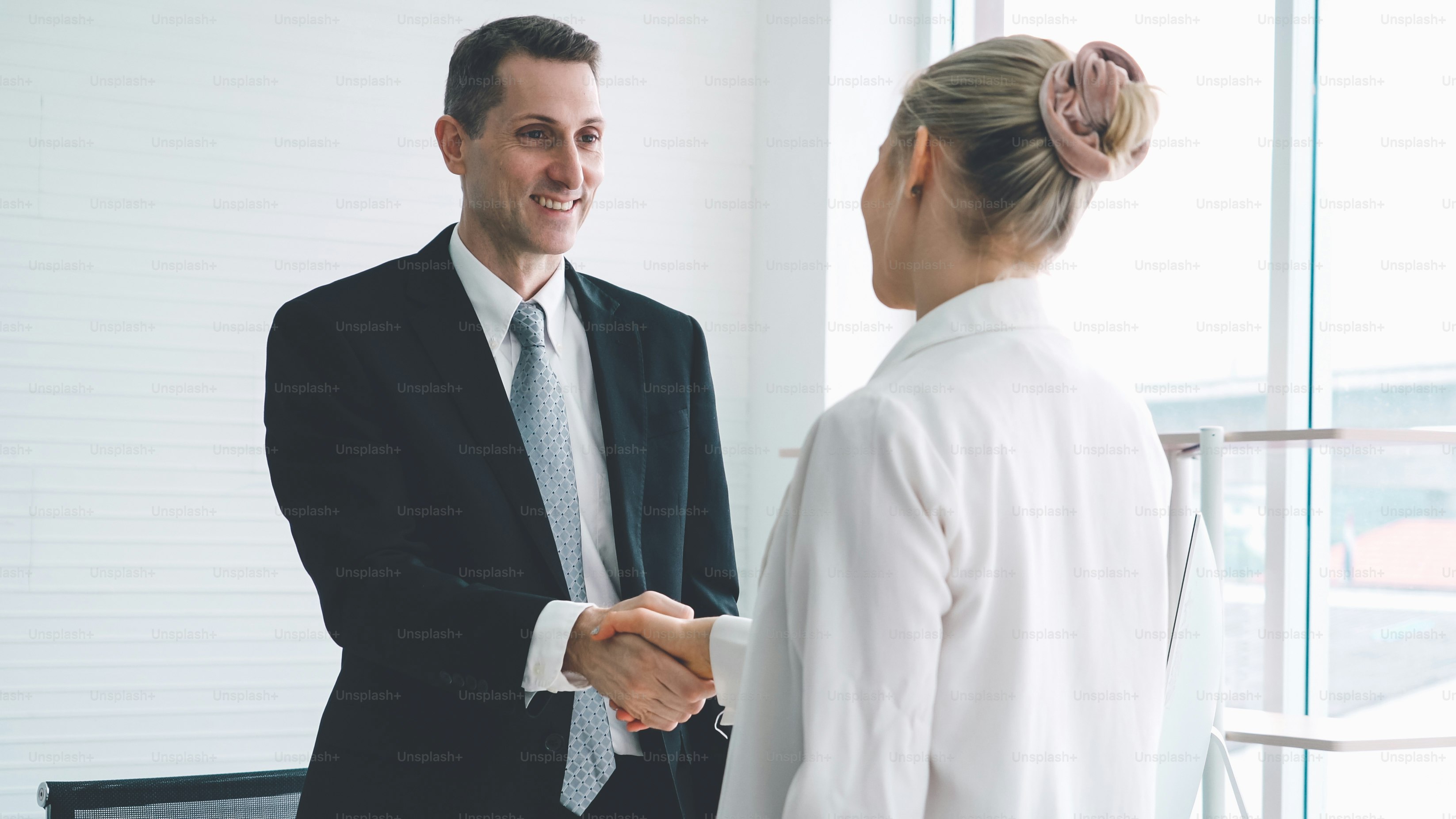 Business people handshake in corporate office showing professional ...