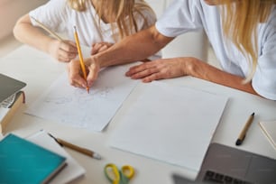 Image of work desk business woman and her daughter while spending time at the drawing lessons in home office