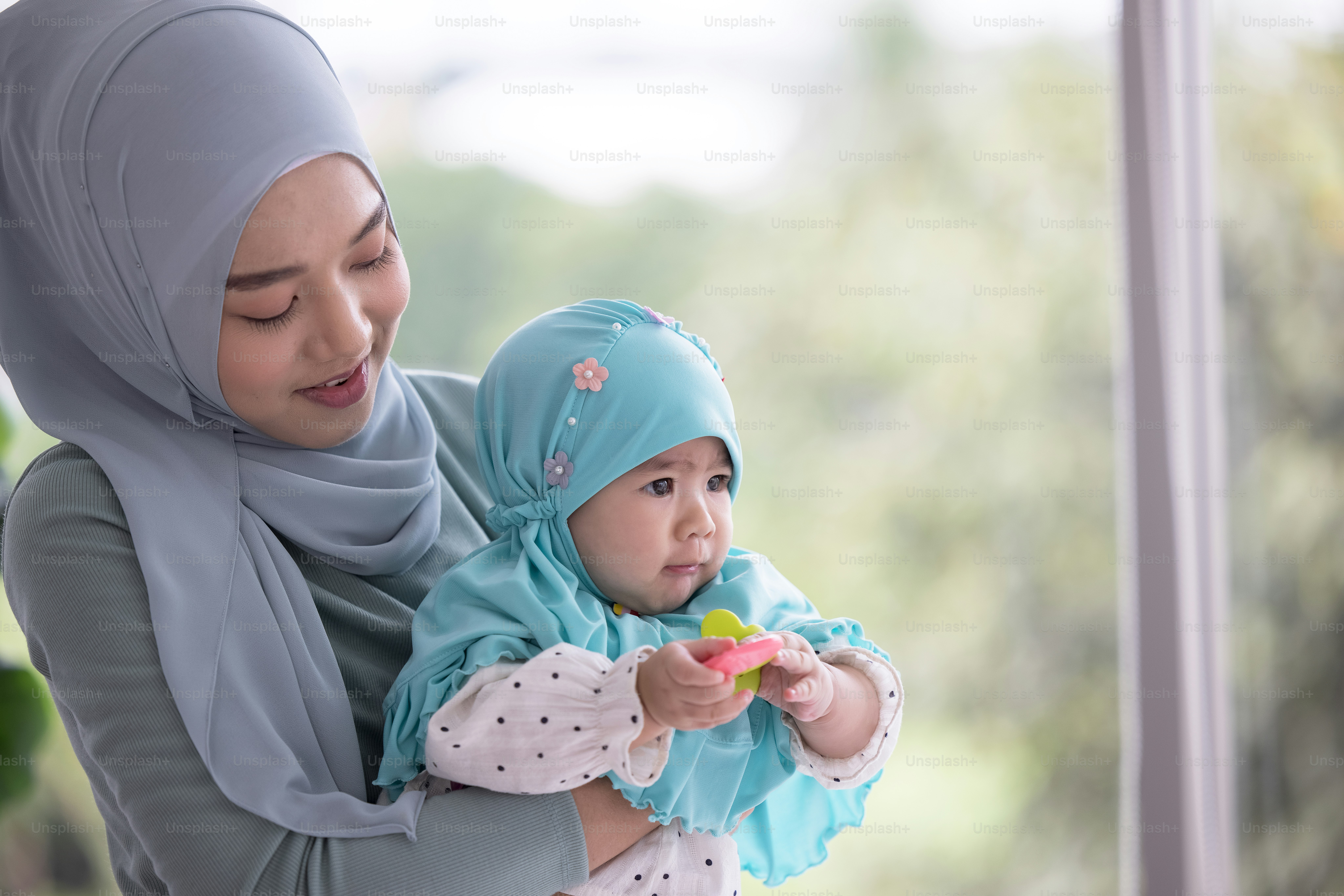 Happy muslim mother holding a beautiful little baby