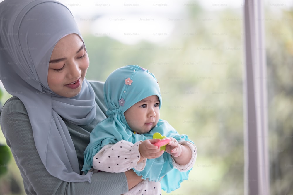 Happy muslim mother holding a beautiful little baby