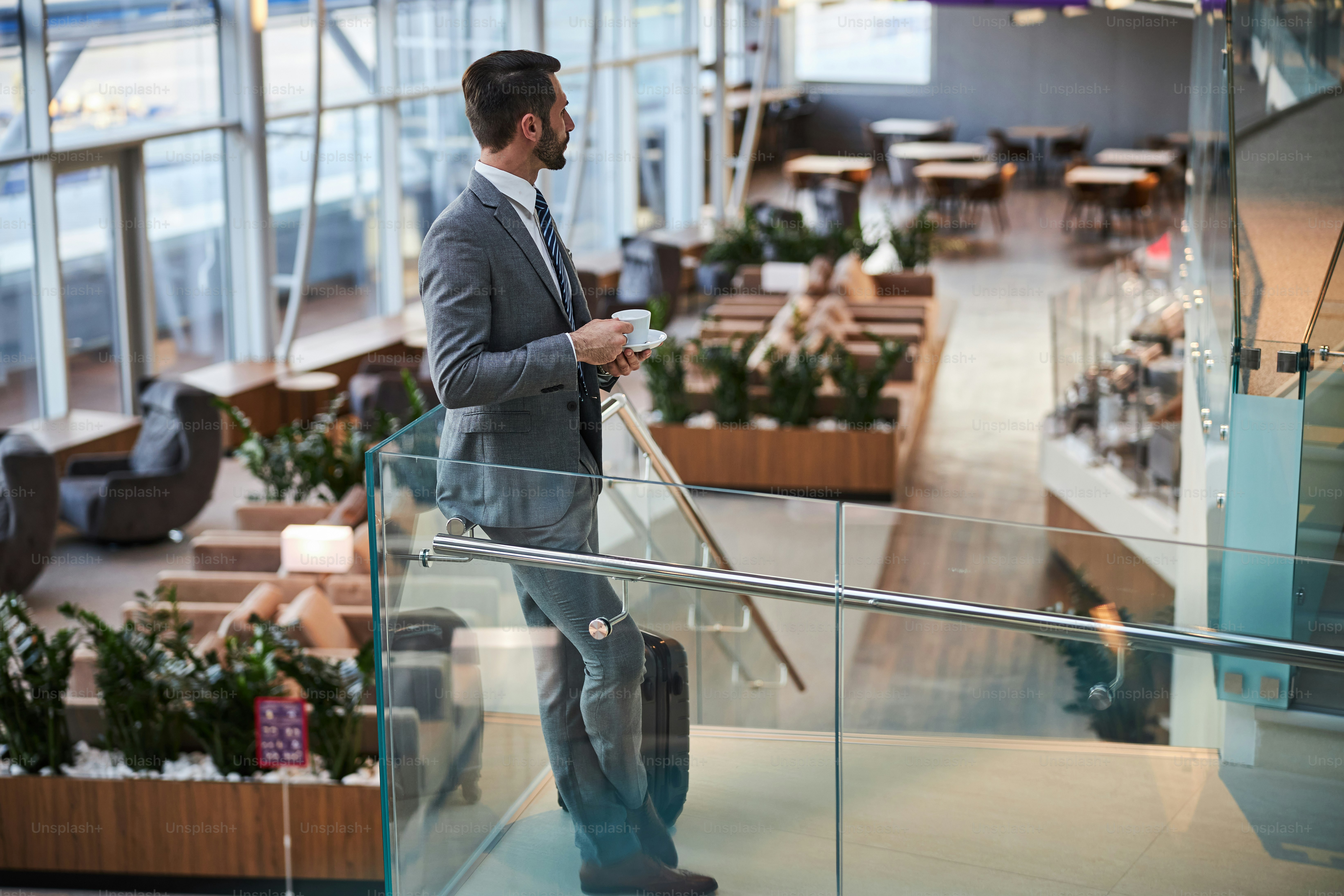 Traveler reviewing premium travel insurance coverage in airport lounge before international flight
