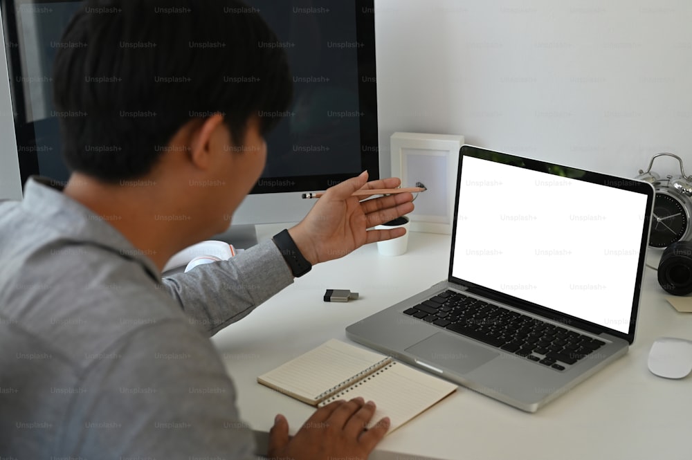 Uomo d'affari che utilizza il computer portatile che effettua una videochiamata e parla della strategia aziendale e del piano aziendale con il collega.