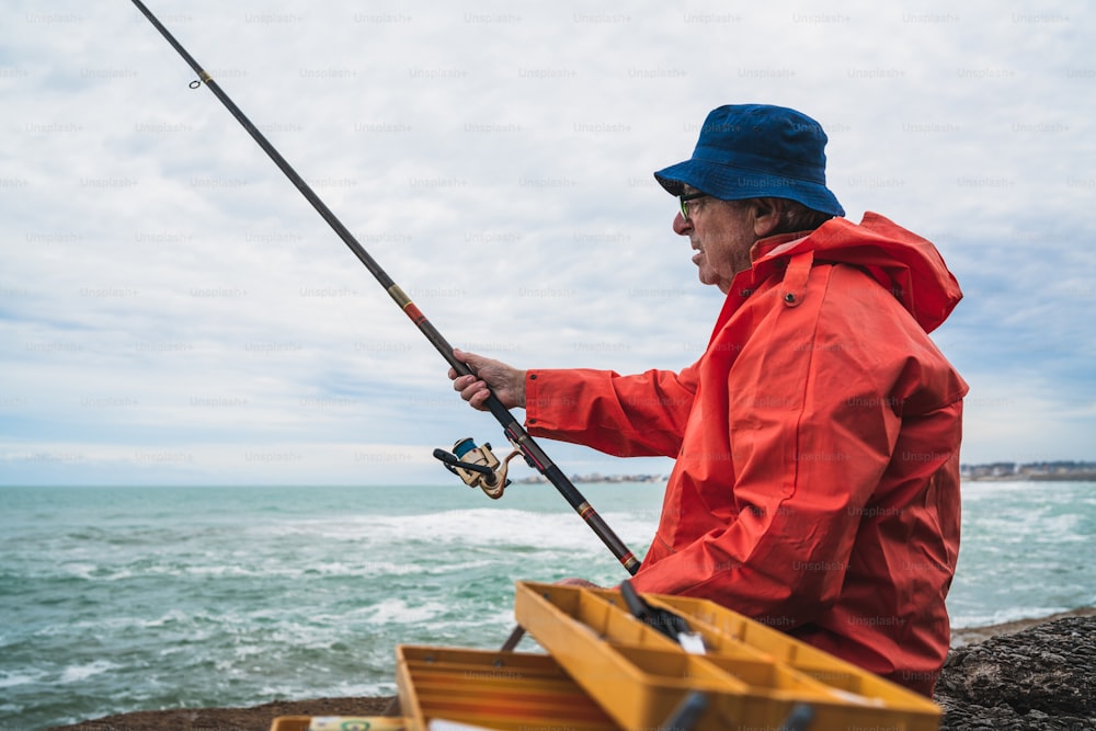 Portrait of an old man fishing in the sea. Fishing concept. photo –  Outdoors Image on Unsplash