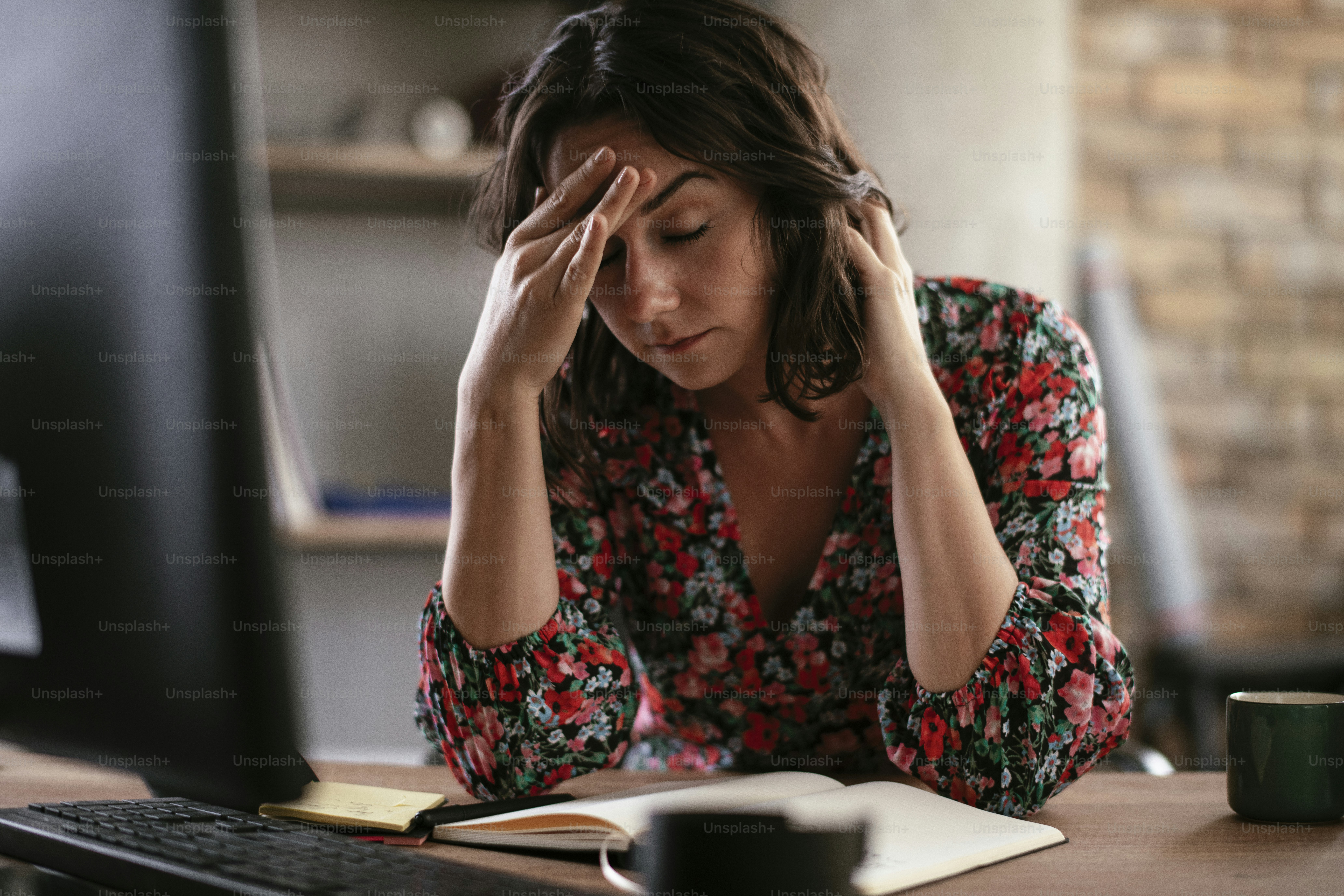 Beautiful businesswoman in office. Tired woman having headache