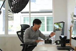 Graphic designer or photographer is working on a project at his work space.