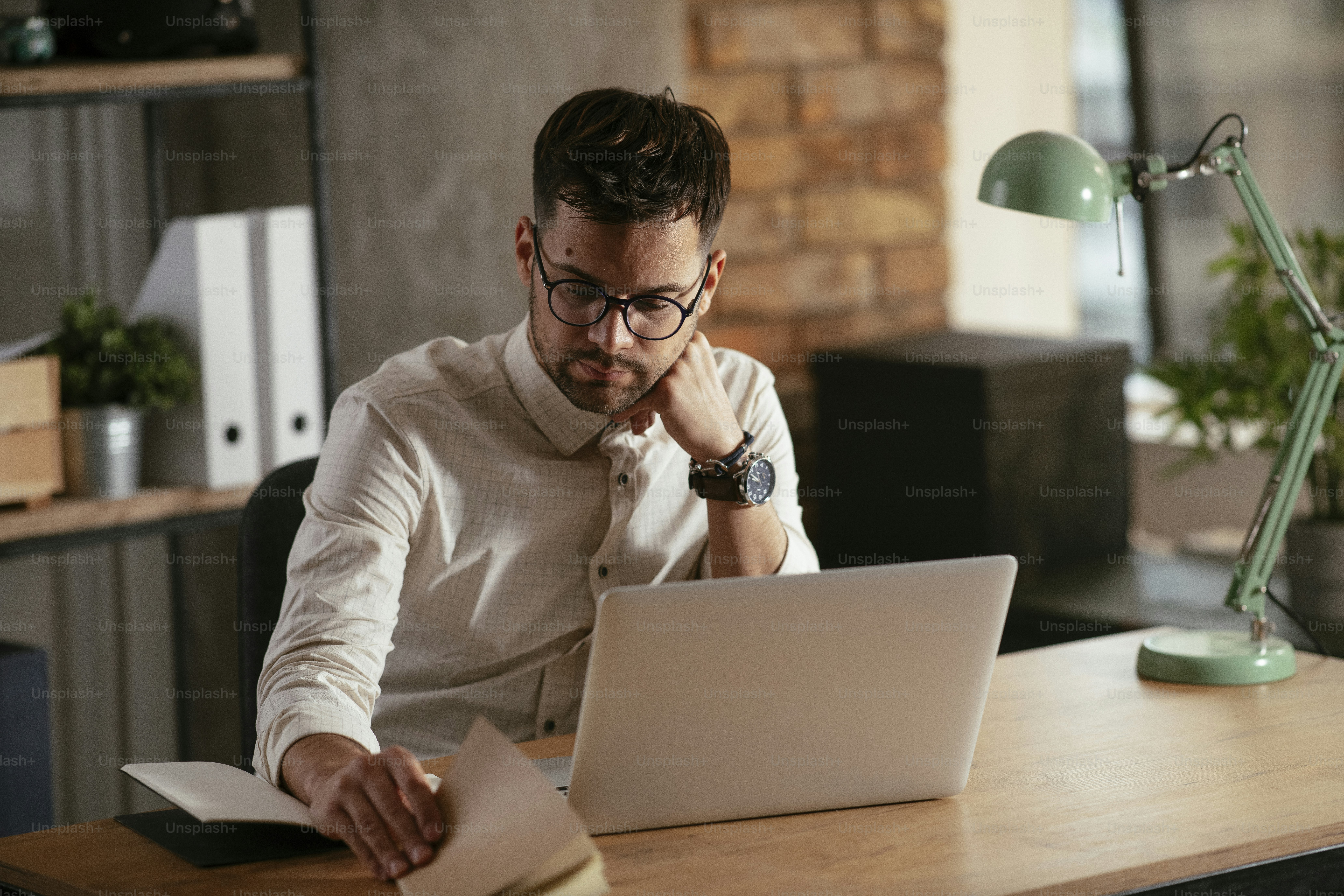 Businessman working in the office on his laptop. Stylish businessman working on a project in the office.