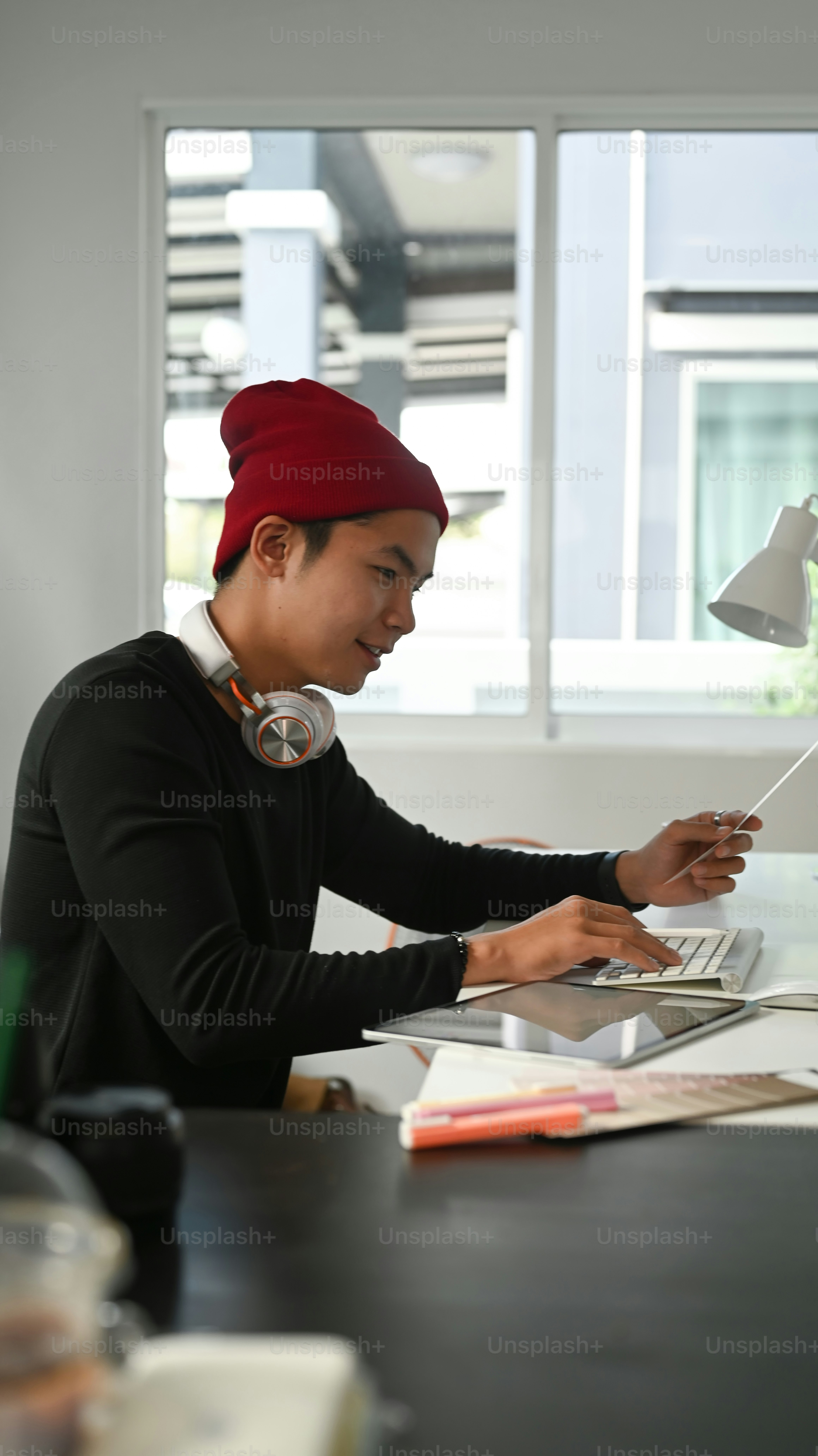 Portrait of graphic designer or photographer is using digitizer and colour sample in his office.