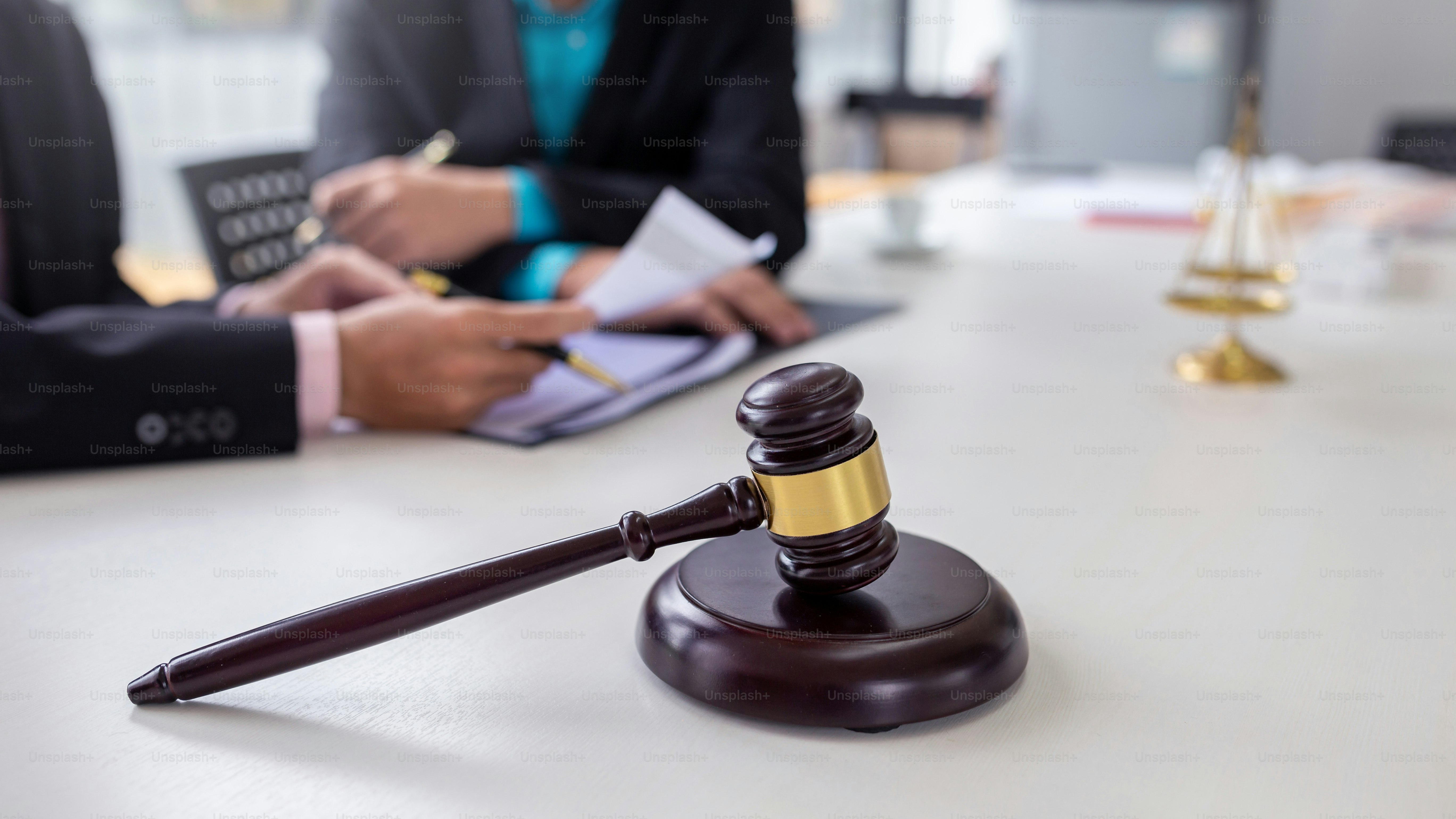 Businessmen and lawyer discuss lawsuits in the office.