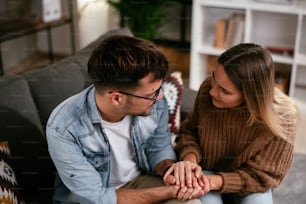 Young man having a problem. Girlfriend comforting her sad boyfriend.