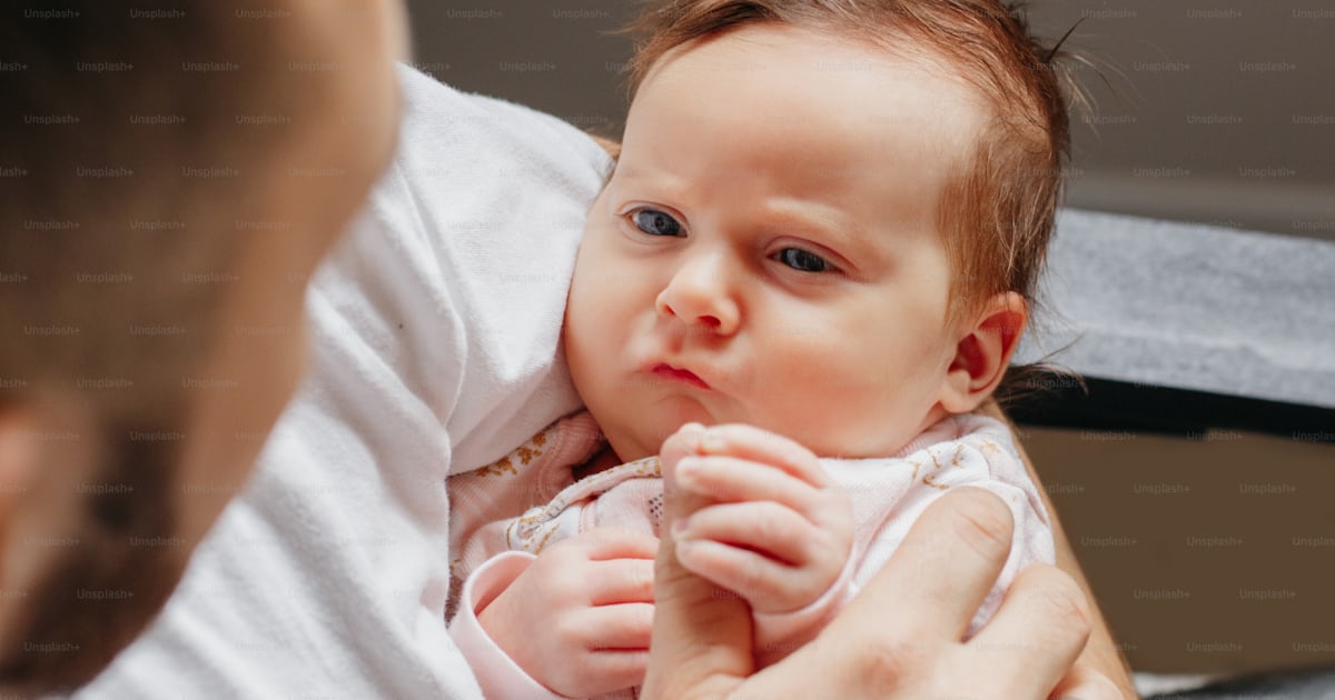 Funny cute adorable baby. Father holding carrying funny newborn infant ...