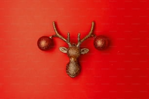 flat lay with christmas reindeer on red background.
