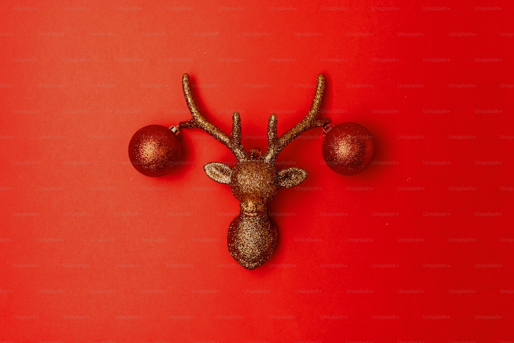 flat lay with christmas reindeer on red background.