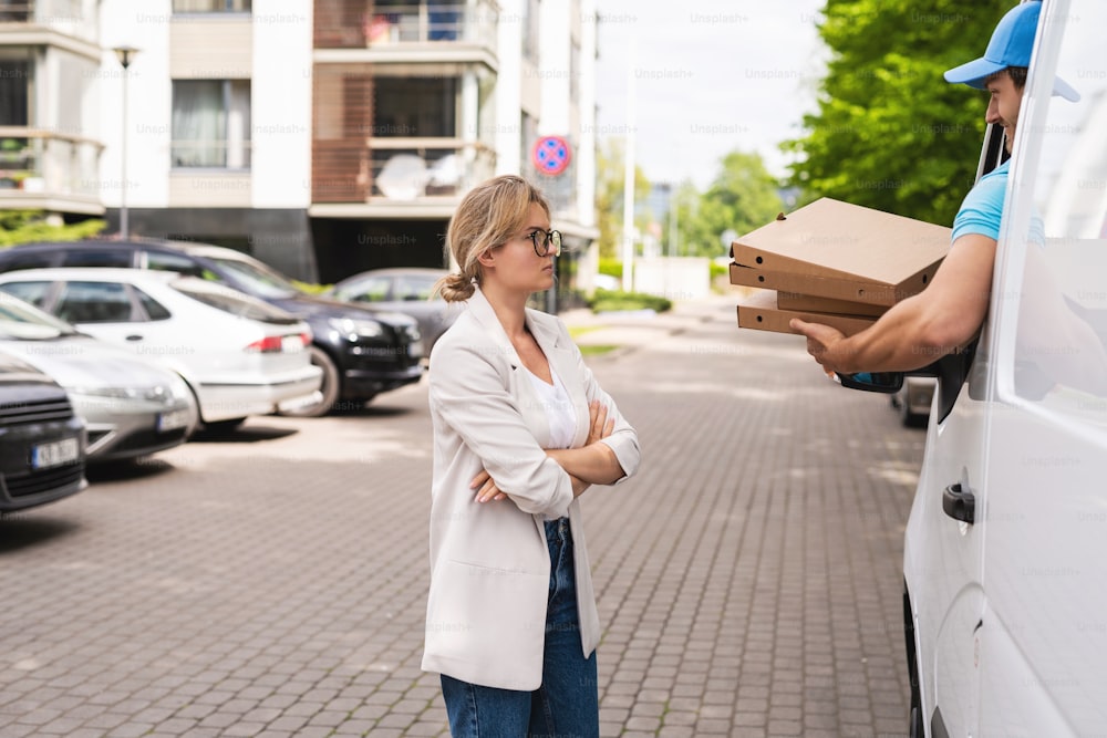 Client dissatisfaction. Angry woman because courier brings wrong pizza or he's too late.