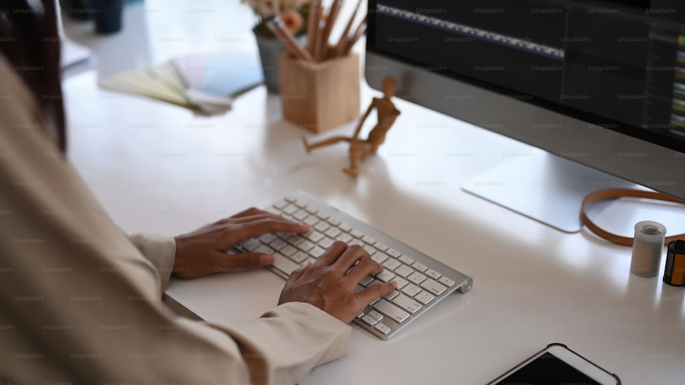 Cropped shot of a female Videographer editor is editing video on her personal computer in the office.