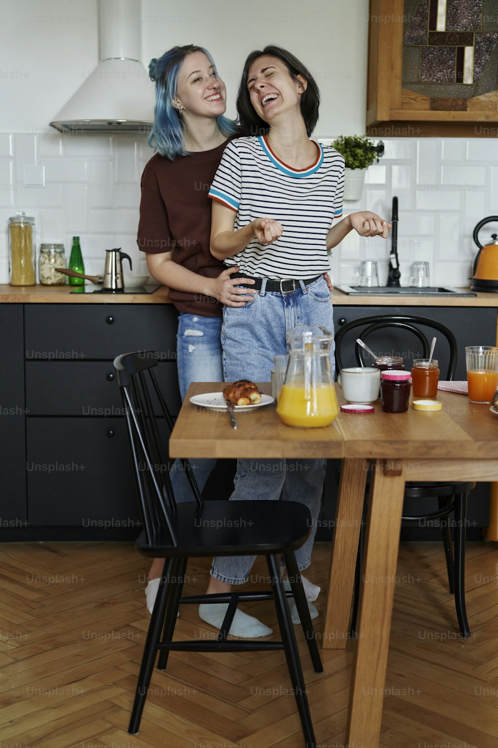 Laughing lesbian couple during breakfast