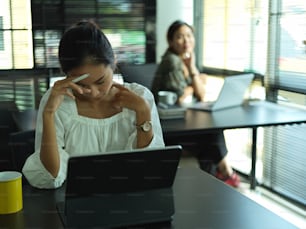 Close up view of businesswoman feeling stressed while working in office room