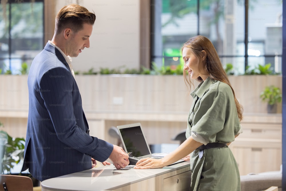 Receptionist Taking Payment With Credit Card, Charge it to my current account at counter in hotel