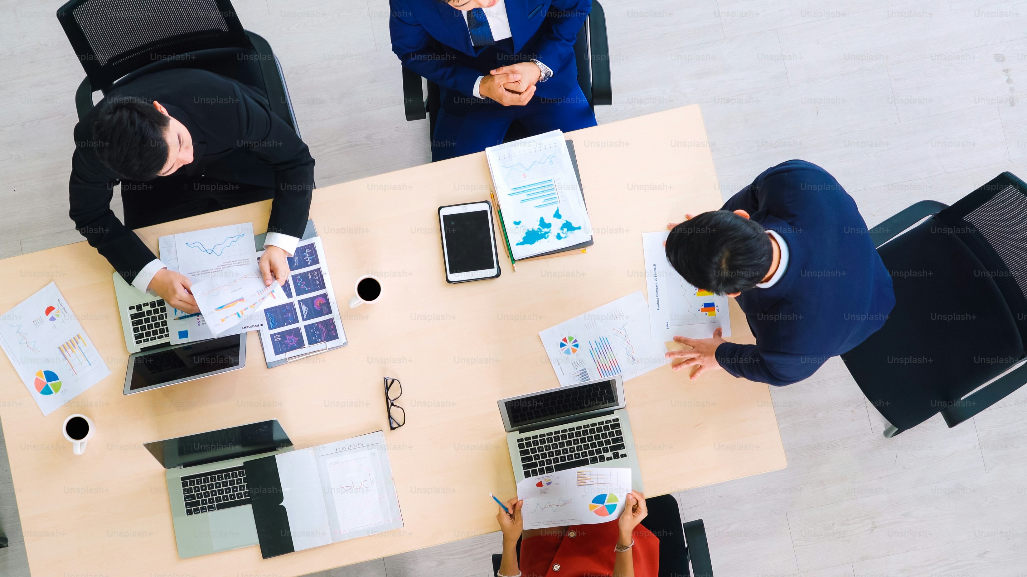 Business people group meeting shot from top view in office . Profession businesswomen, businessmen and office workers working in team conference with project planning document on meeting table .
