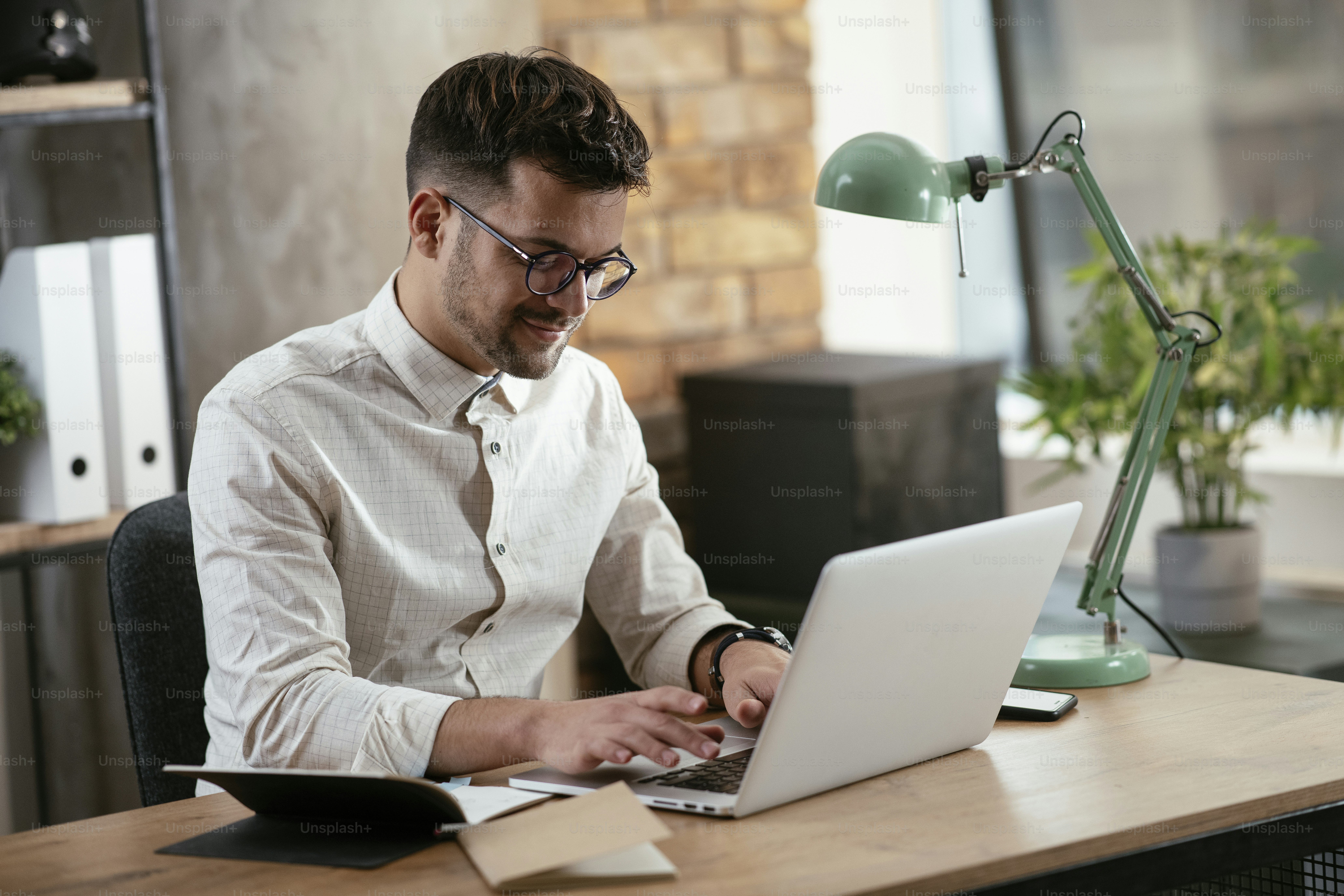 Businessman working in the office on his laptop. Stylish businessman working on a project in the office.