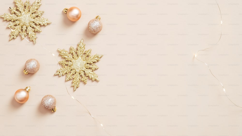 Christmas holiday decorations and garland on pastel beige background. Flat lay, top view.