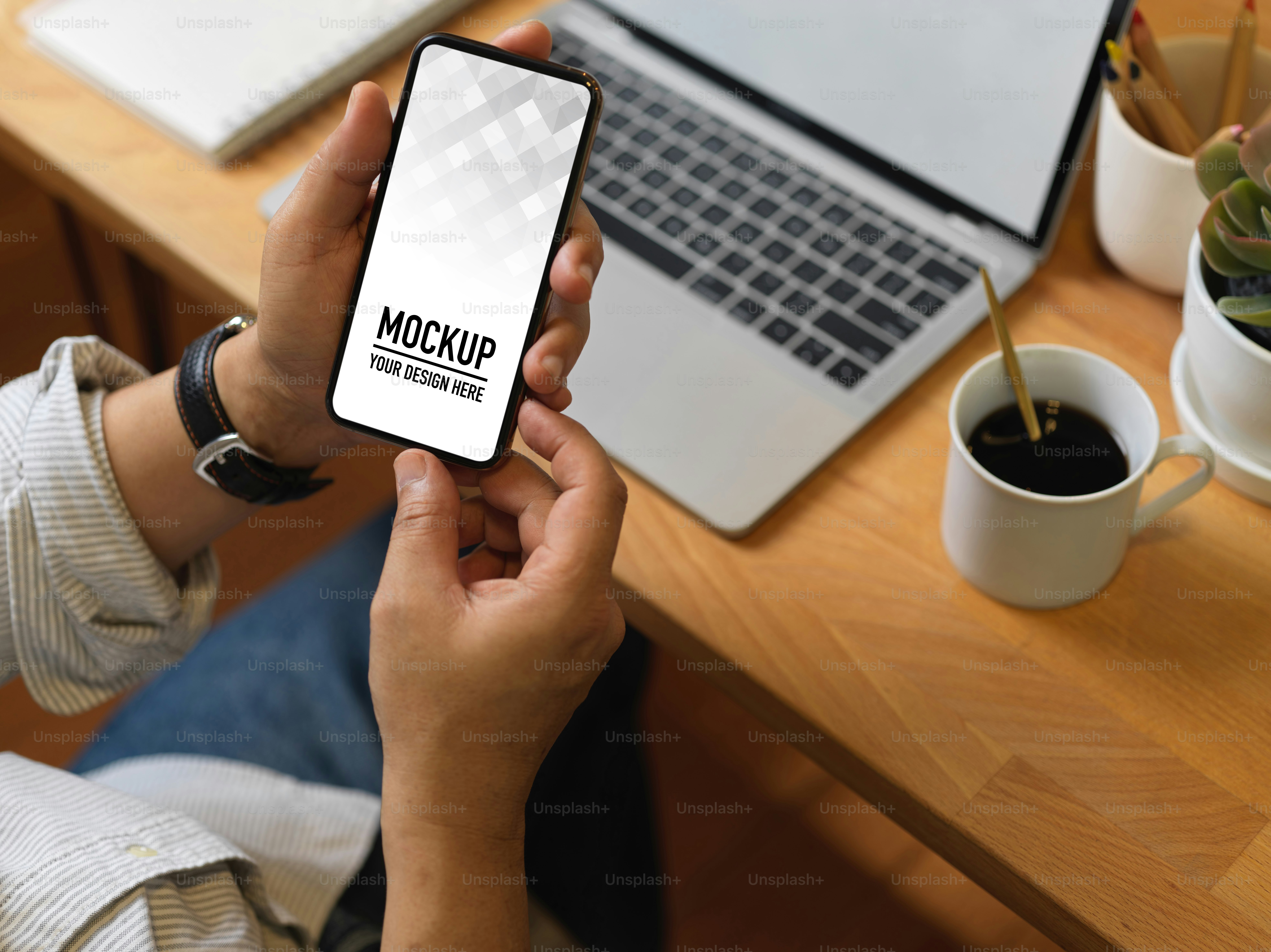 Top view of male hand holding smartphone include clipping path in office room