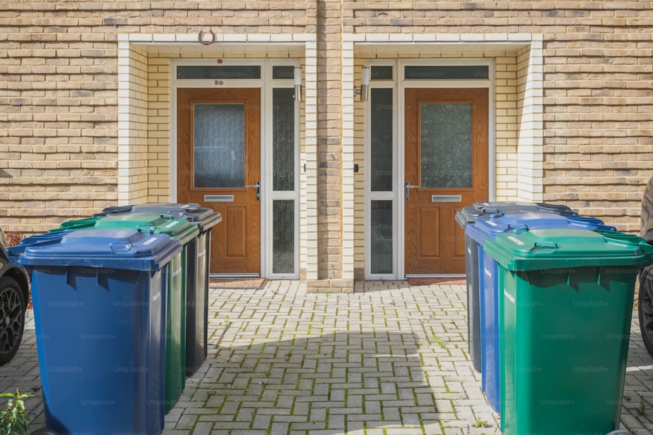 Wheelie bins outside the front doors, labelled for recycling, garden ...